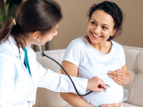 Pregnant woman receiving women's health care